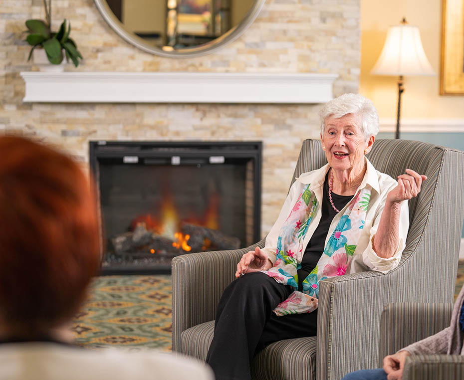 happy senior woman by a fire place