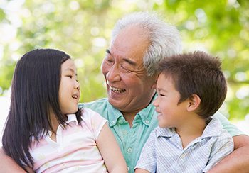 happy senior man with two grandkids